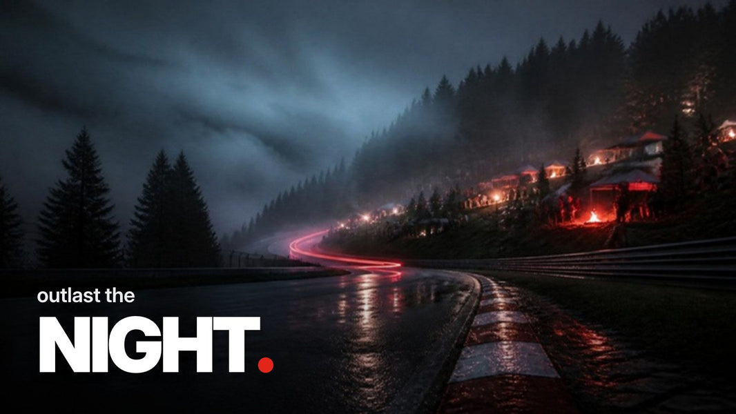 Text 'outlast the NIGHT.' above a photo of a wet, foggy racetrack curve with red-and-white curbs at dawn, with a spectator hill behind featuring tents and glowing campfires in the forest.