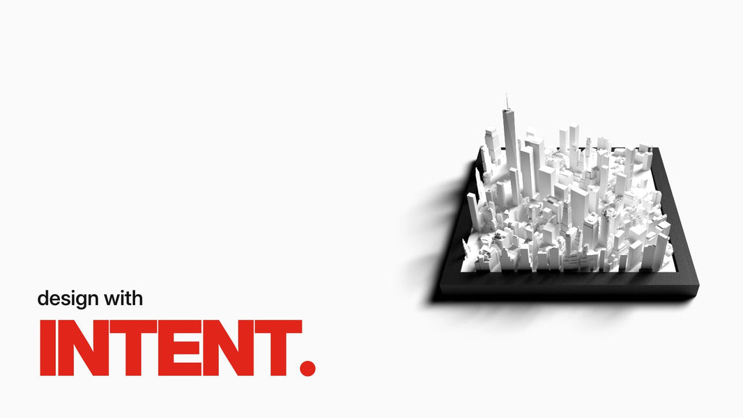 Text 'design with INTENT.' above the City Tile New York, a white 3D city relief of Manhattan's skyscrapers in a black frame, shown at an angle.