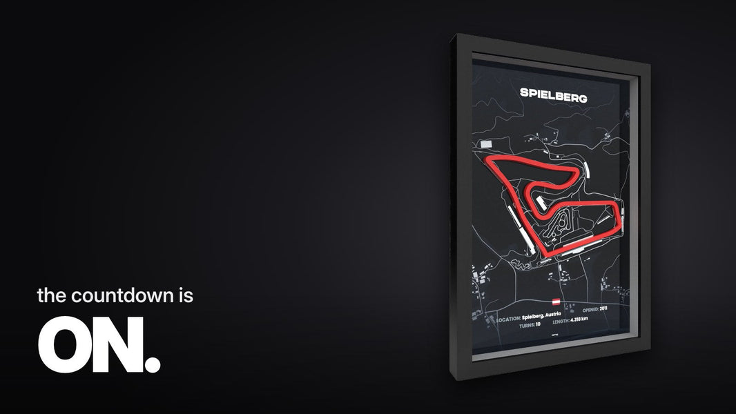 Text 'the countdown is ON.' above the angled photograph of the 3D racetrack frame with a red track line on a dark map in a black frame against a white background.