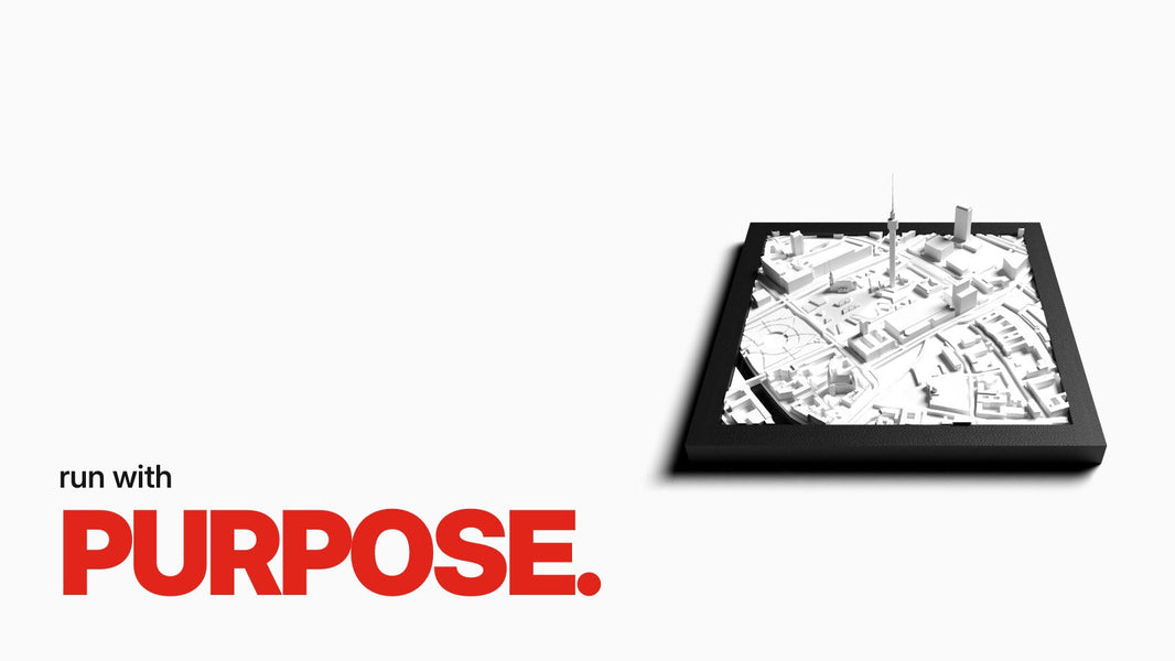 Text 'run with PURPOSE.' above a close-up of an editorial marathon poster with black 3D relief of the marathon route, orange number field, and black frame.