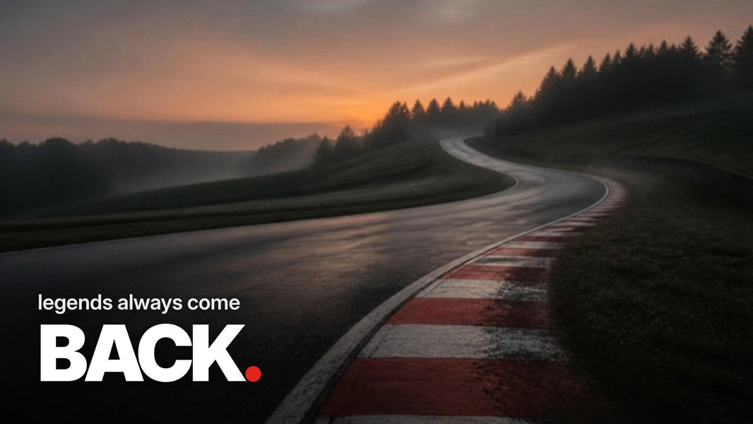 Text 'legends always come BACK.' over a photo of an empty, sweeping race track curve with red-and-white curbs in twilight and light mist.