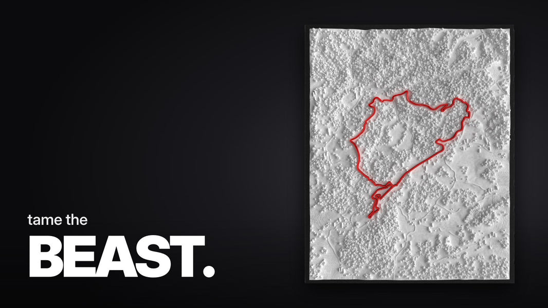 Text 'tame the BEAST.' over a close-up of the red 3D Nordschleife track with shadows behind a reflective acrylic panel.