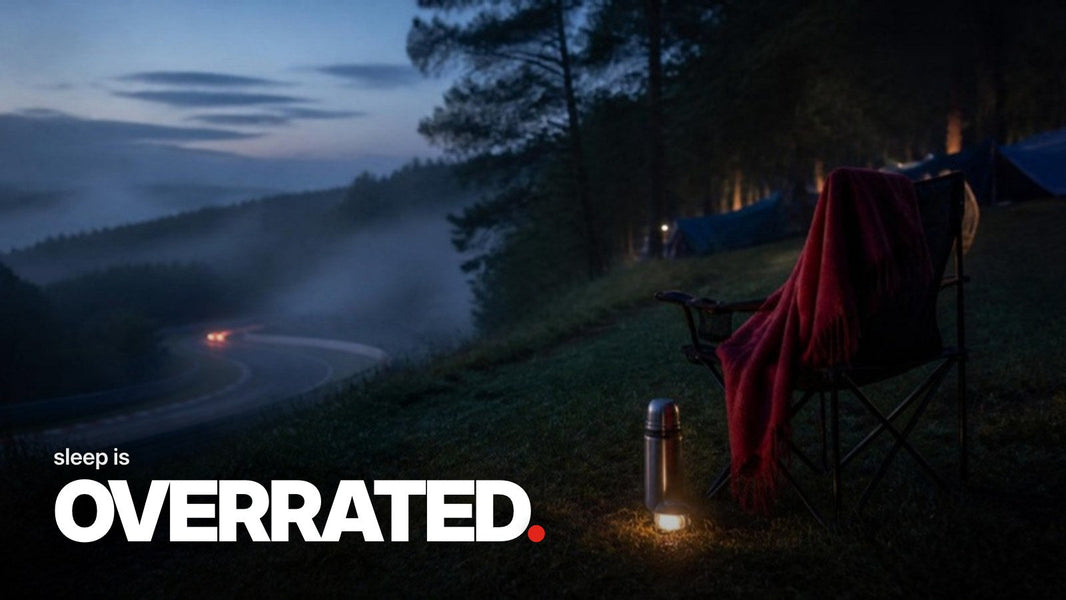 Text 'sleep is OVERRATED.' over a photo of an empty camping chair with a red blanket and headlamp on a spectator hill above a misty racetrack at dusk.